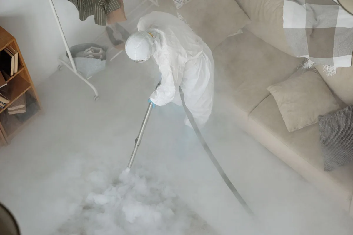 Biohazard cleanup technician in protective equipment, Ithaca, MI